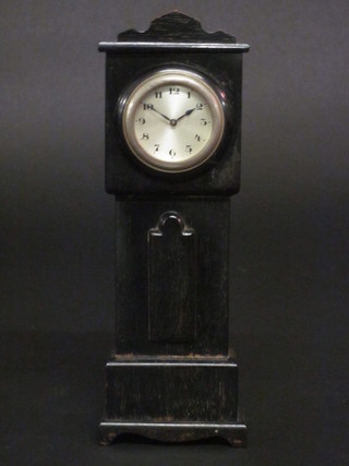An 8 day bedroom timepiece with silvered dial and Arabic numerals, contained in an ebonised miniature clock case