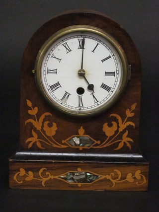 An American shelf clock with painted dial and Roman numerals contained in an arched inlaid mahogany case