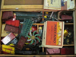 A box containing a collection of red and green Meccano