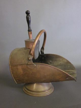 A Victorian copper helmet shaped coal scuttle complete with shovel