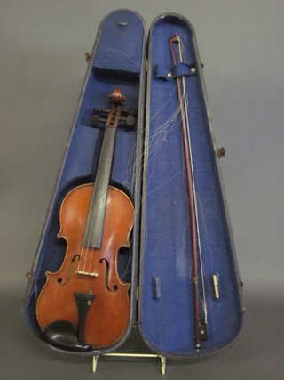 A violin labelled Medio Fino, contained in a wooden carrying  case complete with bow 13"