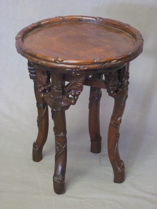 A circular Oriental Padouk drum table, raised on cabriole supports with detachable tray 15"