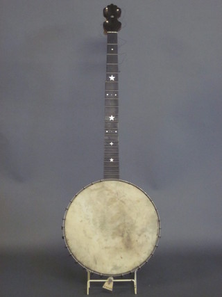 A 4 stringed banjo with 11" drum