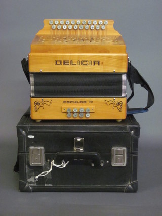 A wooden cased accordion by Delica Popular IV, with 21  buttons, complete with carrying case