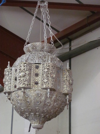 An Eastern style hanging light fitting contained in a pierced metal frame