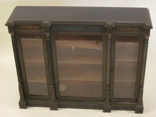 A Victorian ebonised display cabinet fitted shelves enclosed by glazed panelled doors and with columns to the sides 55"