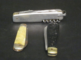 A multi-bladed jack knife and 2 pocket knives
