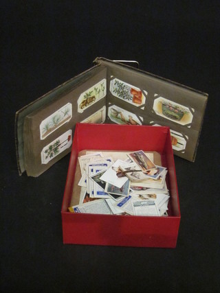 An album of various cigarette cards, an album of loose cigarette cards