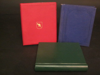 A red plastic album of Australian stamps, a green album of  stamps and 1 other album of stamps