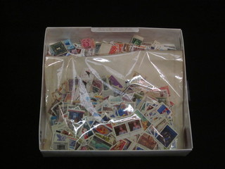 A box containing a collection of loose stamps
