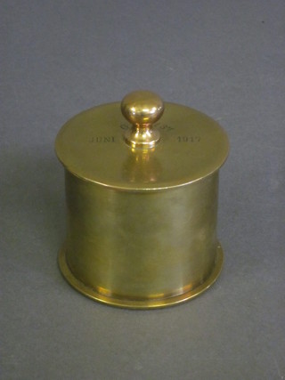 A circular brass jar and cover formed from a WWI Continental  shell case