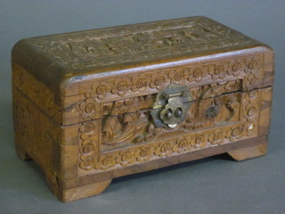 A rectangular carved cedar trinket box with hinged lid