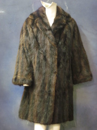 A lady's three-quarter length brown fur coat