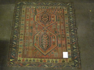 A Persian red ground Persian rug decorated 2 diamonds to the  centre within multi borders 64" x 52", some holes