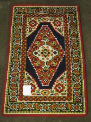 A wool rug with blue ground and diamond to the centre within multi-row borders 59" x 36"