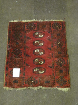 A red ground Afghan rug with 5 octagons to the centre 38" x 73"