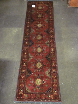 A tan ground runner with 7 octagons to the centre 119" x 29"