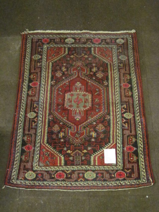 A red ground Persian carpet with diamond to the centre 58" x  42"