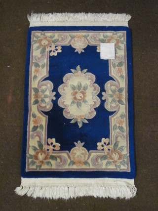 A blue ground and floral patterned Chinese rug 36" x 23"