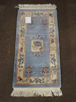 A blue ground floral patterned Chinese rug 48" x 24"