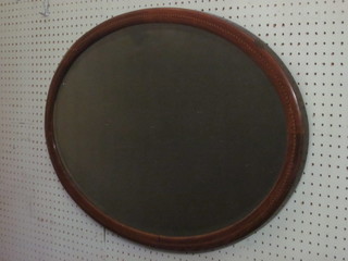 An Edwardian oval bevelled plate wall mirror contained in an inlaid mahogany frame 31"