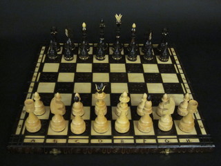A large wooden chess set and folding board