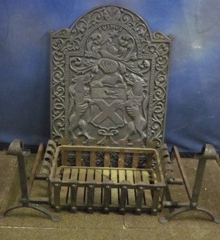 An arch shaped fire back with armorial decoration 21" together  with a fire basket and dogs