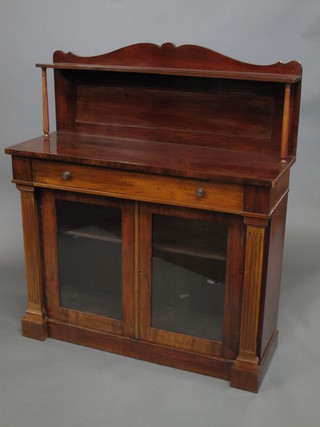 A 19th Century mahogany chiffonier with raised back, fitted a  shelf, the base fitted a drawer above a cupboard enclosed by  glazed panelled doors and with fluted columns to the side 42"   ILLUSTRATED