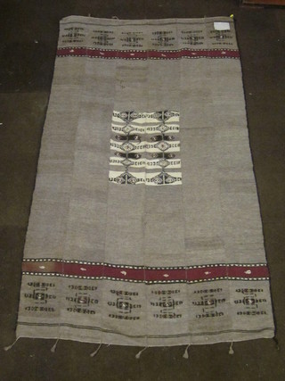 A beige ground African rug 92" x 52", slight hole