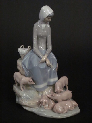 A Lladro figure of a seated lady with piglets, based incised D415  10" long