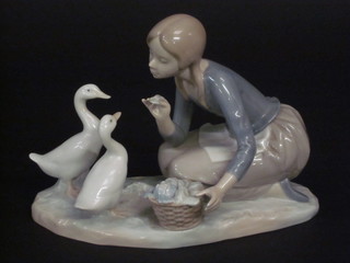 A Lladro figure group of a kneeling girl with geese, base marked 4849, 9"