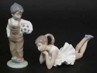 A Nao figure of a standing boy with a football and a do. reclining girl 8"
