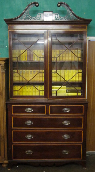 A Georgian style mahogany bookcase on cabinet with pierced broken pediment and dentil cornice, the interior fitted adjustable  shelves enclosed by astragal glazed doors, the base fitted 2 short  and 3 long drawers, raised on splayed bracket feet, 48"