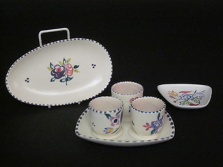 A Poole Pottery 3 piece condiment set, together with an oval  shaped dish 7" and a shaped dish 3"