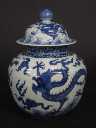 An Oriental blue and white jar and cover the base decorated  dragons, the base with 6 character mark 11"