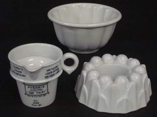 A white glazed Pyramid kitchen measure, a white glazed Shelley  jelly mould and a Green & Co white glazed jelly mould