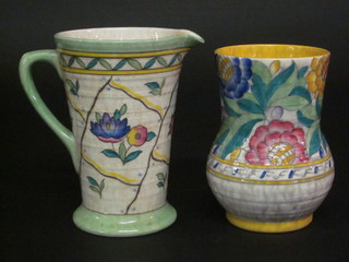 A Ducal Charlotte Rhead style jug, base marked 6016L 8",  cracked, together with a Crown Ducal Charlotte Rhead ribbed  vase with floral decoration 7", cracked