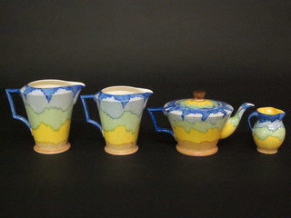 An Art Deco style Ivoryware teapot with yellow and blue decoration and 3 matching jugs