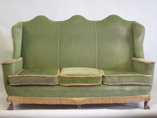 A beech framed Queen Anne style winged triple chair back  settee, upholstered in green material, raised on cabriole supports  66"
