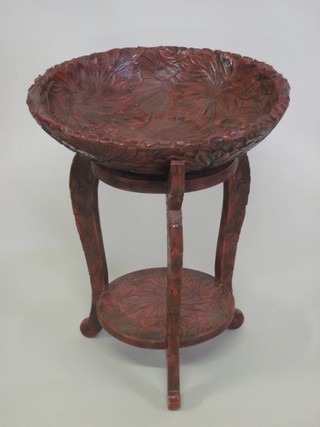 A circular carved Eastern bowl raised on a 2 tier stand, carved chrysanthemums 21"