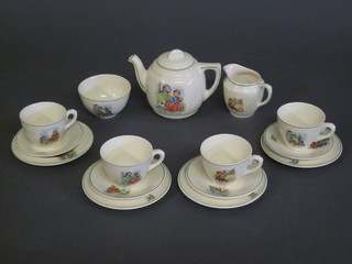 A childs 15 piece pottery dolls house teaset decorated nursery rhymes, comprising teapot, sugar bowl, milk jug, 4 plates and 4  cups and 4 saucers
