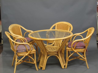 A good quality bamboo conservatory suite comprising circular table with plate glass top 39" and 4 open arm chairs
