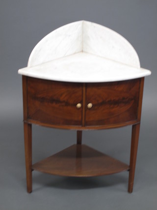 A Georgian mahogany bow front corner wash stand with white  veined marble three-quarter gallery, enclosed by a pair of  panelled doors with undertier, raised on square tapering supports  27"