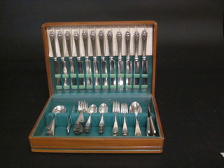 A canteen of silver plated flatware by Rogers Bros. contained in  a walnut canteen box