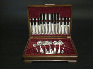 A canteen of silver plated flatware contained in a walnut canteen  box