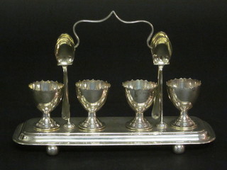 A silver plated egg cruet complete with spoons
