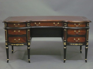 A Georgian style shaped mahogany desk with inset tooled  writing surface above 1 long and 6 short drawers 62"