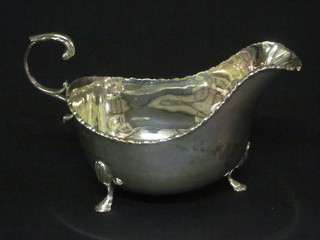 A silver sauce boat with C scroll handle raised on hoof supports, Birmingham 1913, 3 ozs