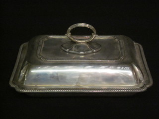 A rectangular silver plated entree dish and cover