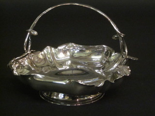 A square silver plated cake basket, raised on a circular spreading  foot 9"